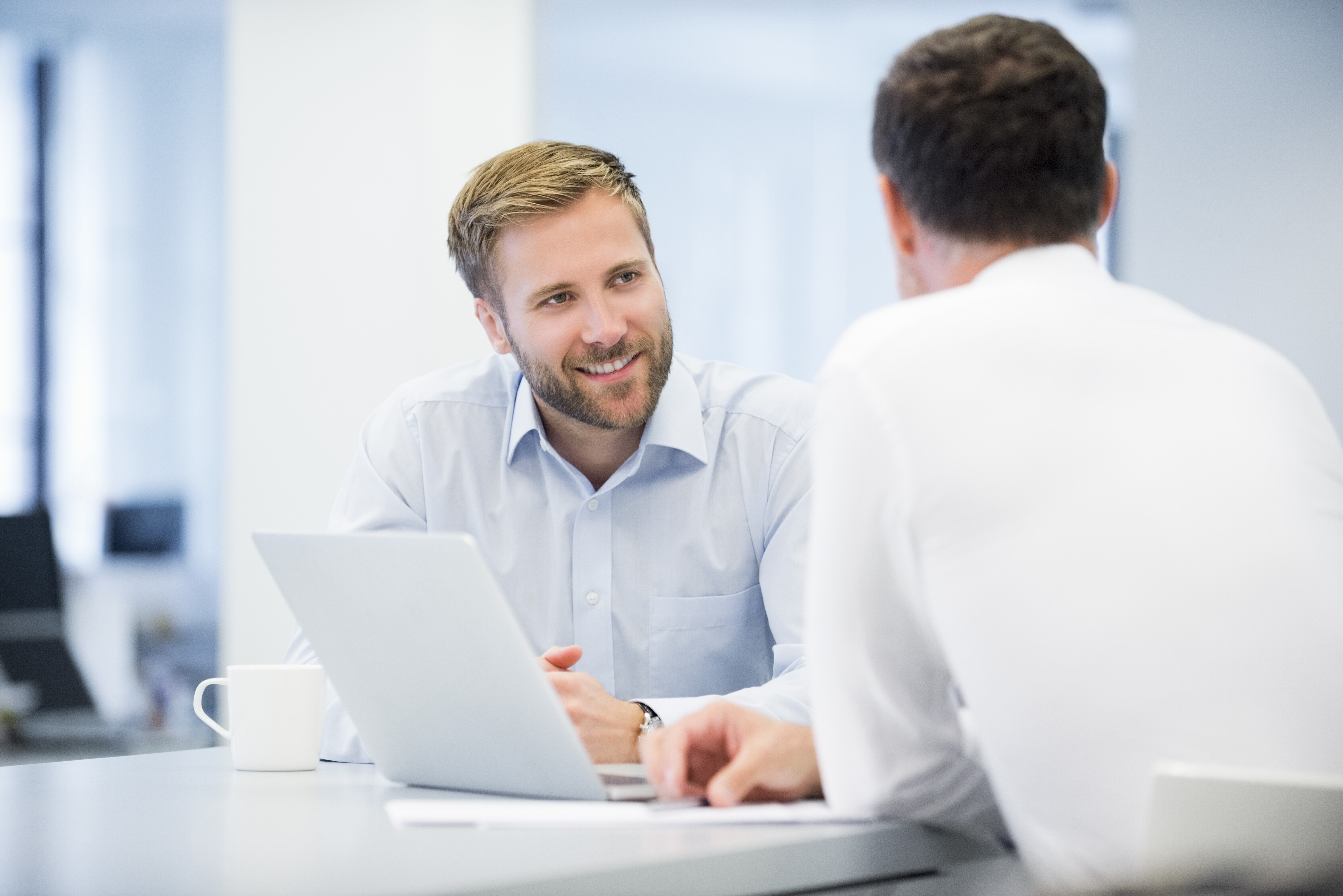 Businessman Discussing With Male Colleague